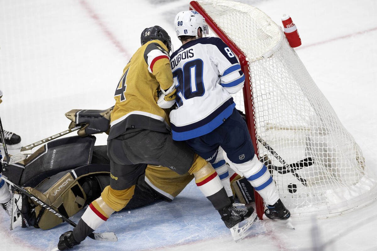 Winnipeg Jets left wing Pierre-Luc Dubois (80) scores on Golden Knights goaltender Laurent Bros ...