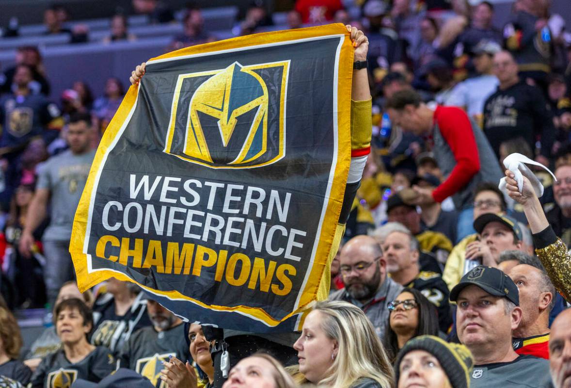 A fan holds up a Western Conference Champions banner as the Golden Knights battle the Winnipeg ...