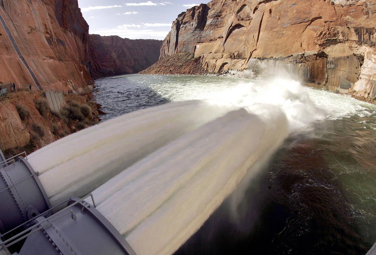 Water flows from the number one and two jet tubes at the Glen Canyon Dam on Wednesday, March 5, ...