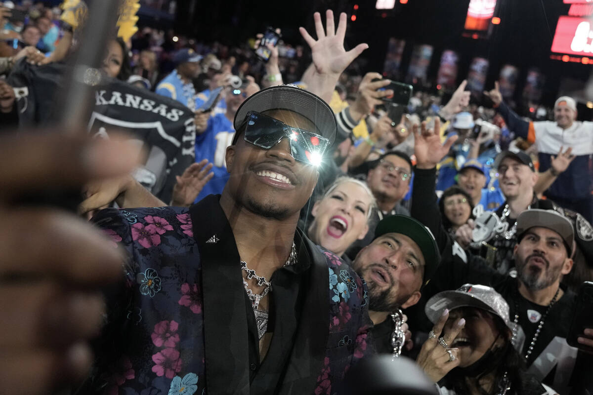 Texas Tech defensive lineman Tyree Wilson takes a selfie with fans after being chosen by the La ...