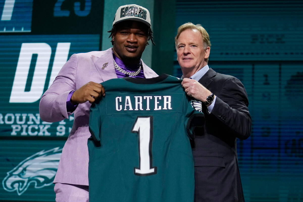 Georgia defensive lineman Jalen Carter, left, poses with NFL Commissioner Roger Goodell after b ...