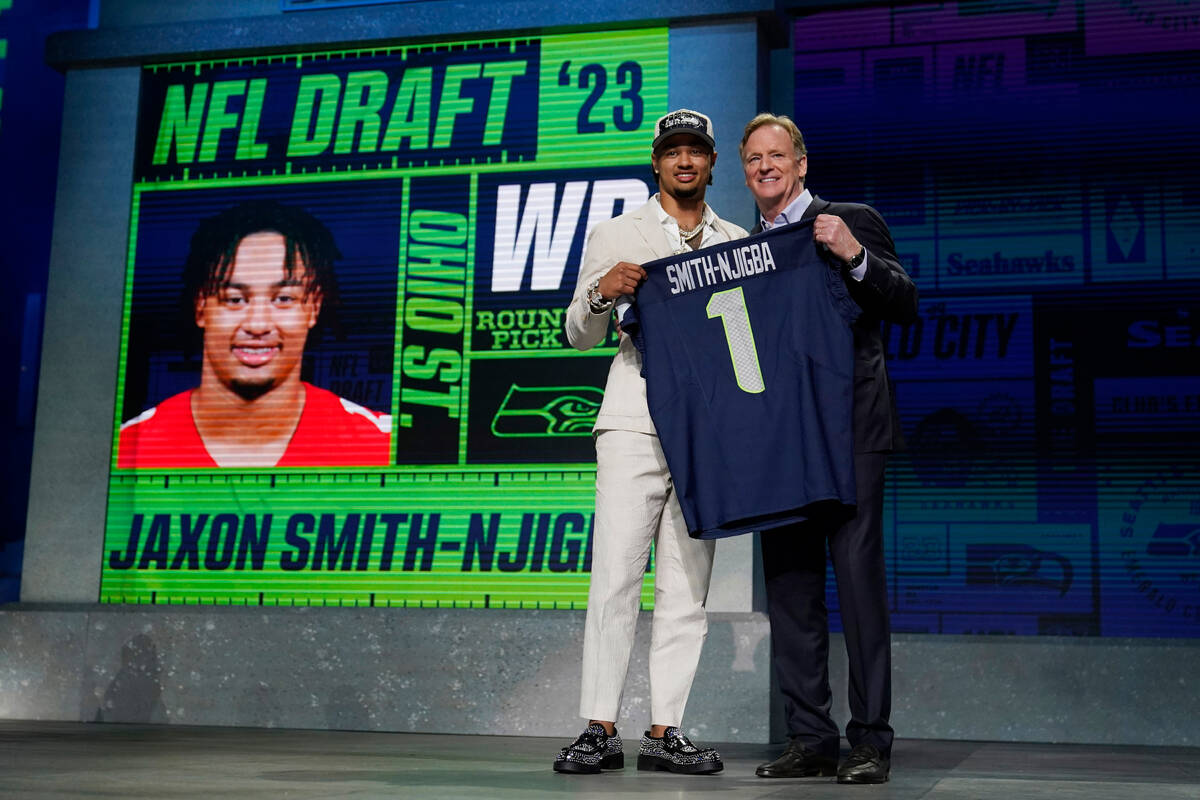 Ohio State wide receiver Jaxon Smith-Njigba, left, poses with NFL Commissioner Roger Goodell af ...