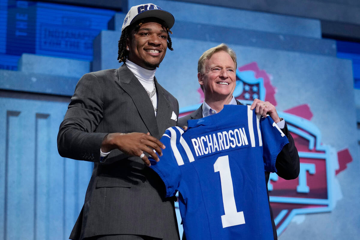 Florida quarterback Anthony Richardson, left, poses with NFL Commissioner Roger Goodell after b ...