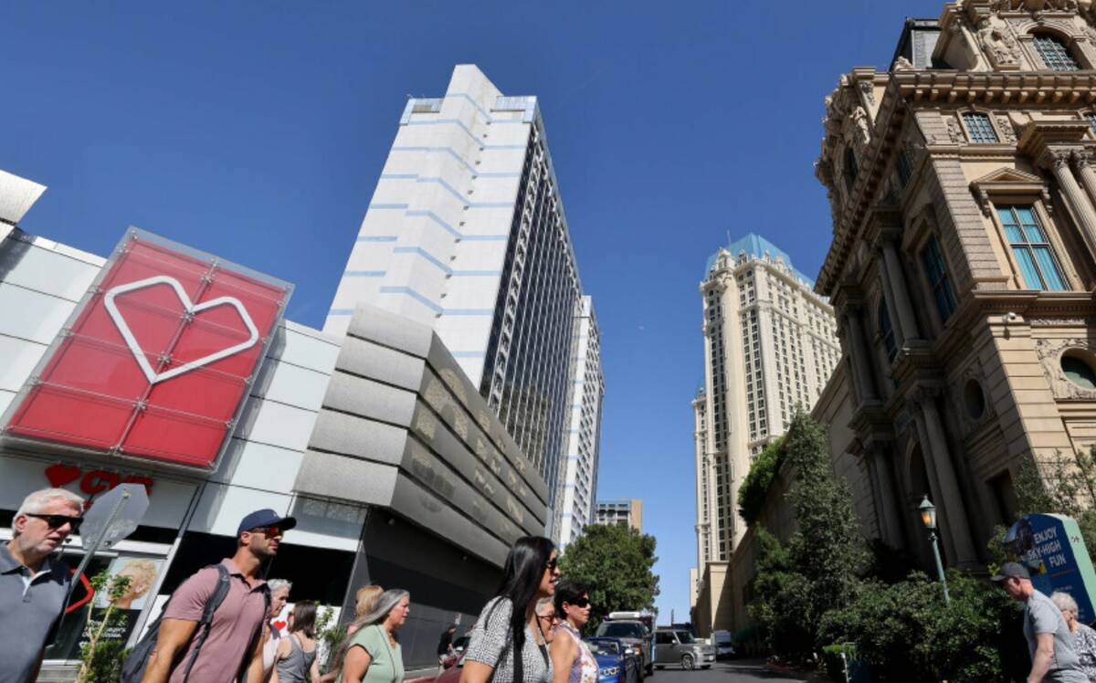 Pedestrians walk between the Horseshoe Las Vegas, left, and Paris Las Vegas on the Strip Friday ...