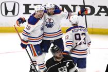 Edmonton Oilers' Leon Draisaitl (29) celebrates with Zach Hyman (18) and Ryan Nugent-Hopkins af ...