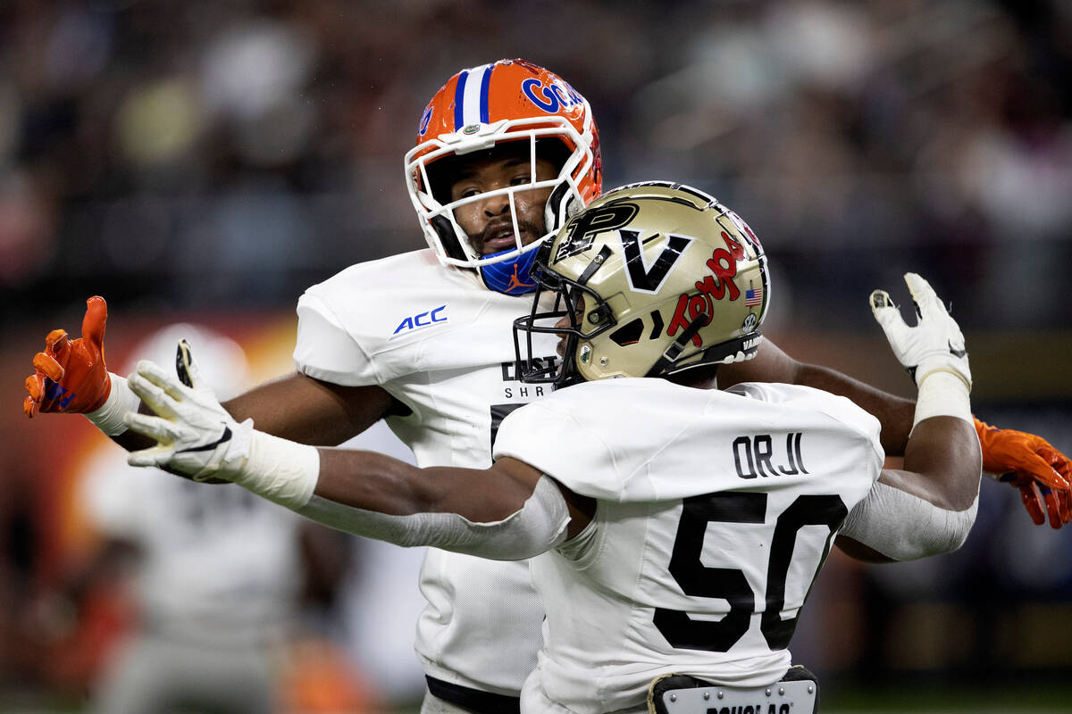 East linebacker Amari Burney of Florida, left, bumps chests with teammate Anfernee Orji of Vand ...