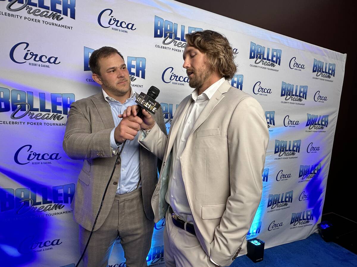 Vikings center Garrett Bradbury, left, and Raiders punter A.J. Cole are shown on the blue carpe ...