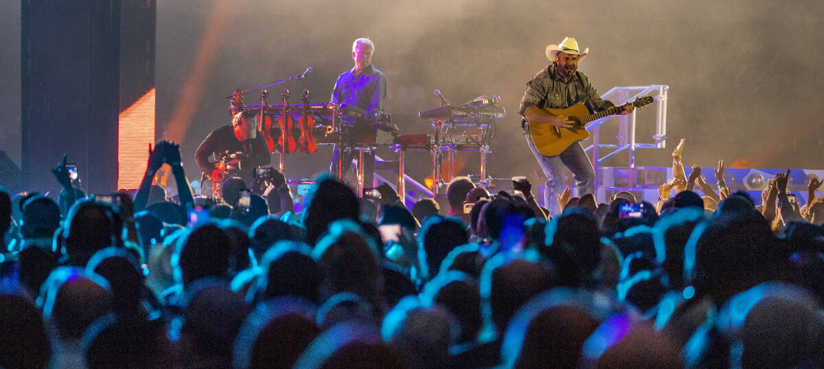 Garth Brooks performs before the crowd at Allegiant Stadium on Friday, July 10 2021, in Las Veg ...