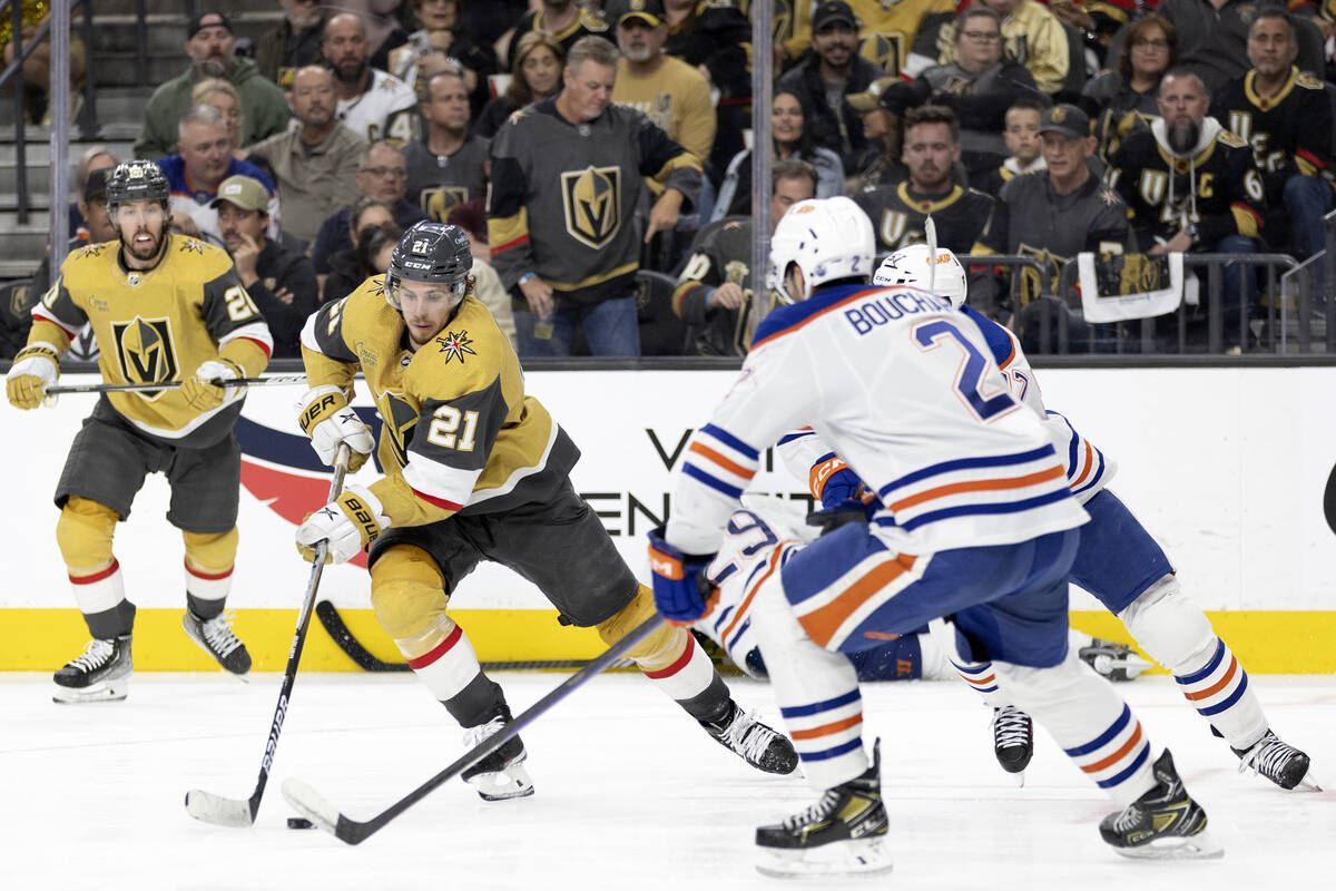 Golden Knights center Brett Howden (21) handles the puck against Edmonton Oilers center Connor ...