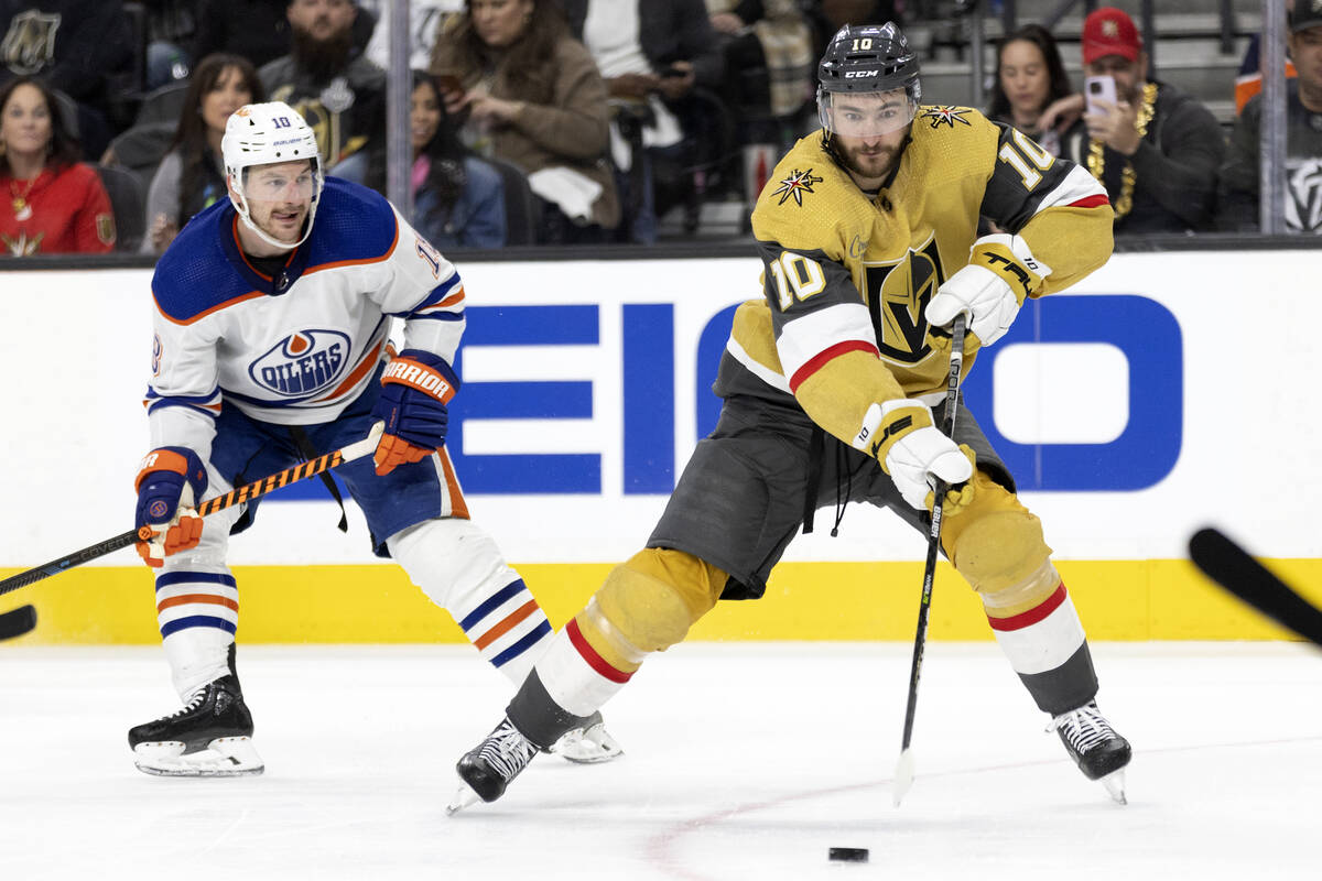 Golden Knights center Nicolas Roy (10) skates with the puck while Edmonton Oilers center Derek ...