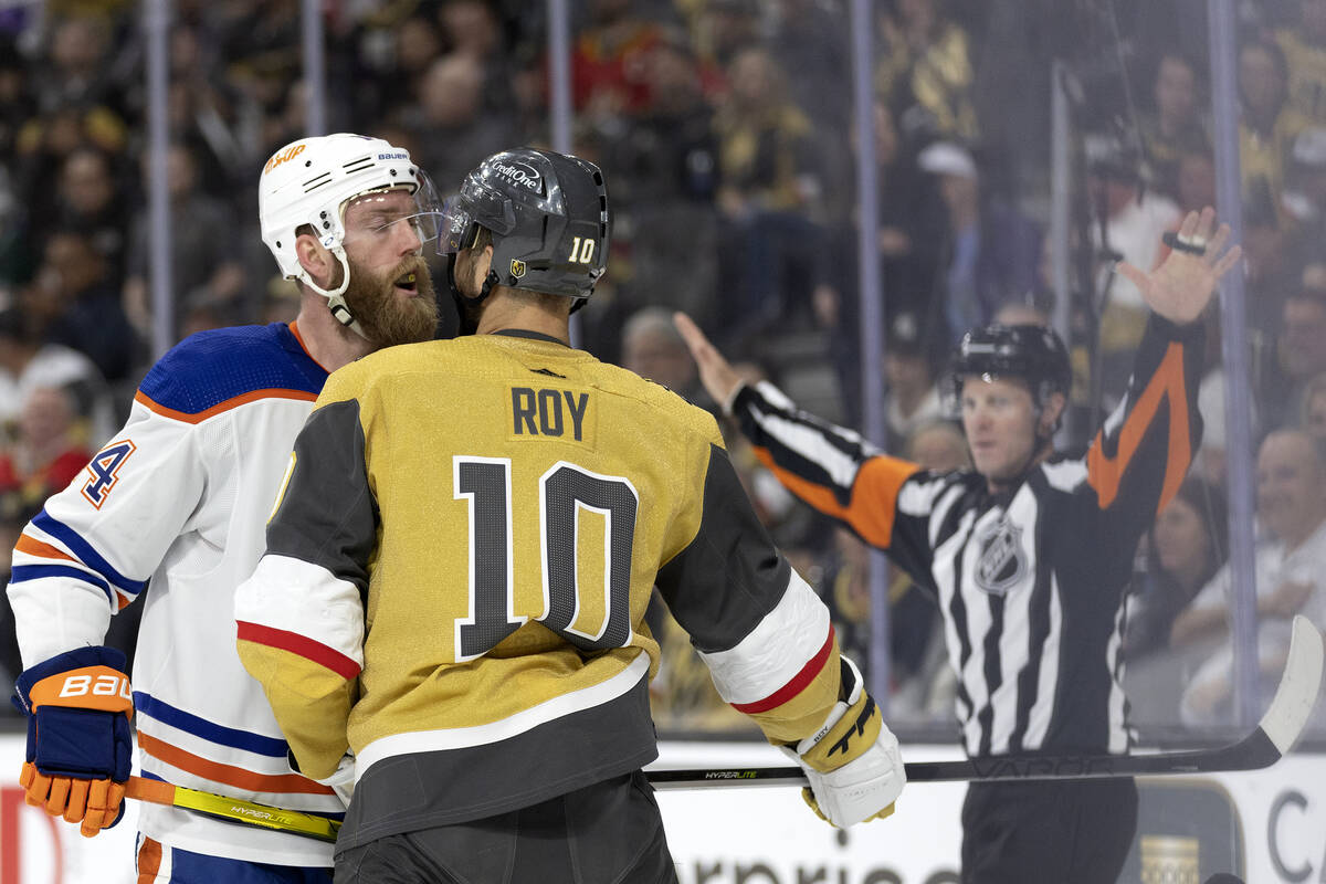 Edmonton Oilers defenseman Mattias Ekholm (14) gets Golden Knights center Nicolas Roy’s ...