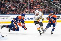 Vegas Golden Knights' Michael Amadio (22) works for the puck between Edmonton Oilers' Vincent D ...