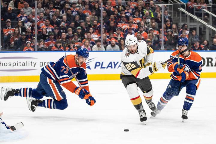 Vegas Golden Knights' Michael Amadio (22) works for the puck between Edmonton Oilers' Vincent D ...