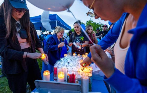 Candles are lit for Tabatha Tozzi, 26, recently killed and now honored during a vigil with fami ...