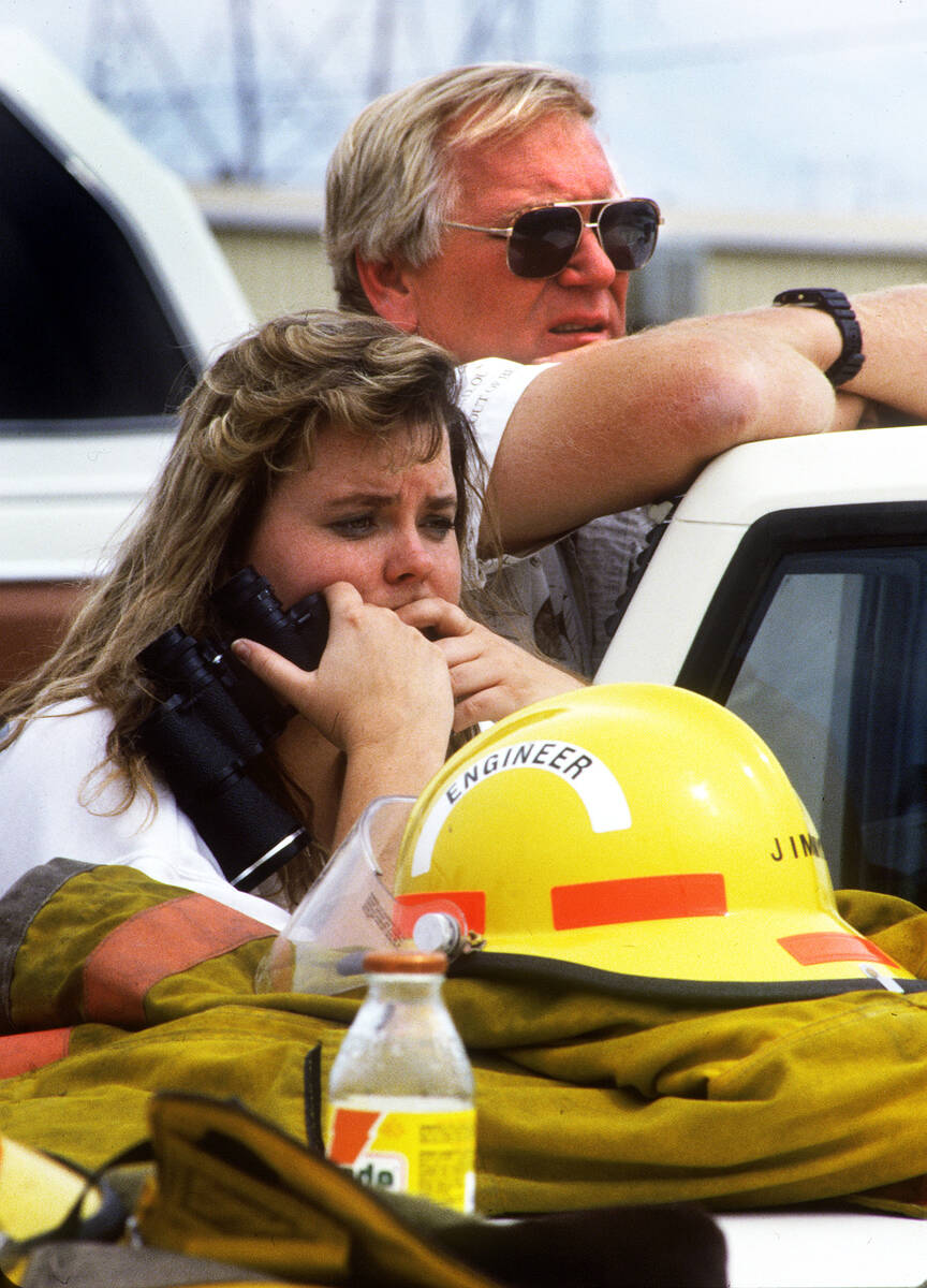 Kendra Brown, left, and Pat Hinds who work at Unicorn Sailing Center, watch from outside their ...