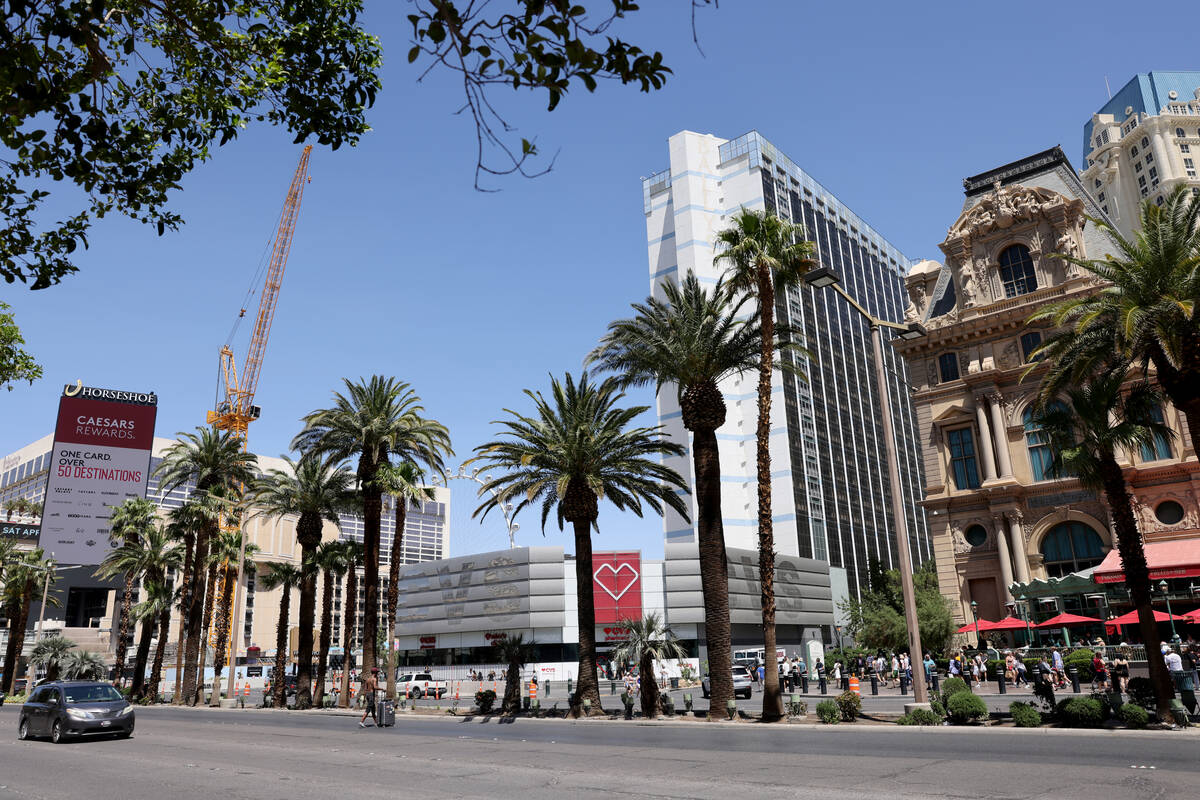 Pedestrians walk between the Horseshoe Las Vegas and Paris Las Vegas on the Strip Friday, April ...