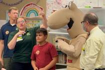 Fifth-grader Edin C. (red shirt) and Mojave Max at Richard J. Rundle Elementary School on Wedne ...