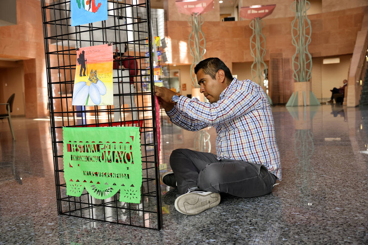 Juan Carlos Varillas Lima helps set up an exhibit by visiting Mexican artist Olegario Hernánde ...