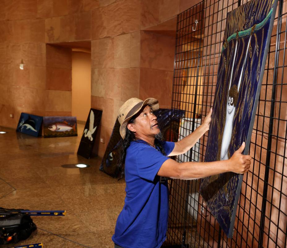 Visiting Mexican artist Olegario Hernández Mendoza hangs some of his art in the rotunda at the ...