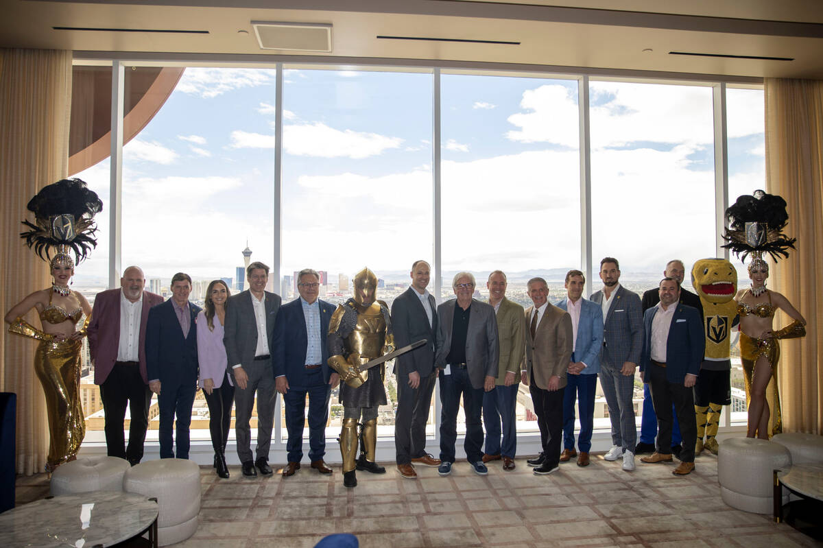 Members of the Vegas Golden Knights organization and Scripps Sports pose for a photo flanked by ...