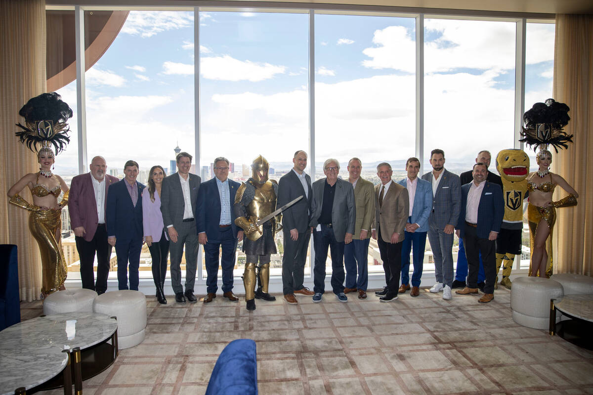 Members of the Vegas Golden Knights organization and Scripps Sports pose for a photo flanked by ...