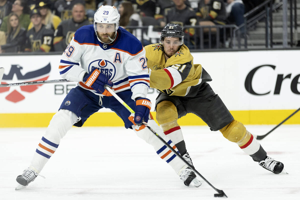 Golden Knights center Brett Howden (21) skates for the puck against Edmonton Oilers center Leon ...