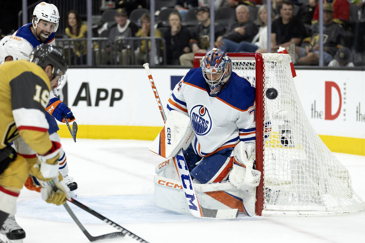 Golden Knights right wing Reilly Smith (19) shoots while Edmonton Oilers goaltender Stuart Skin ...