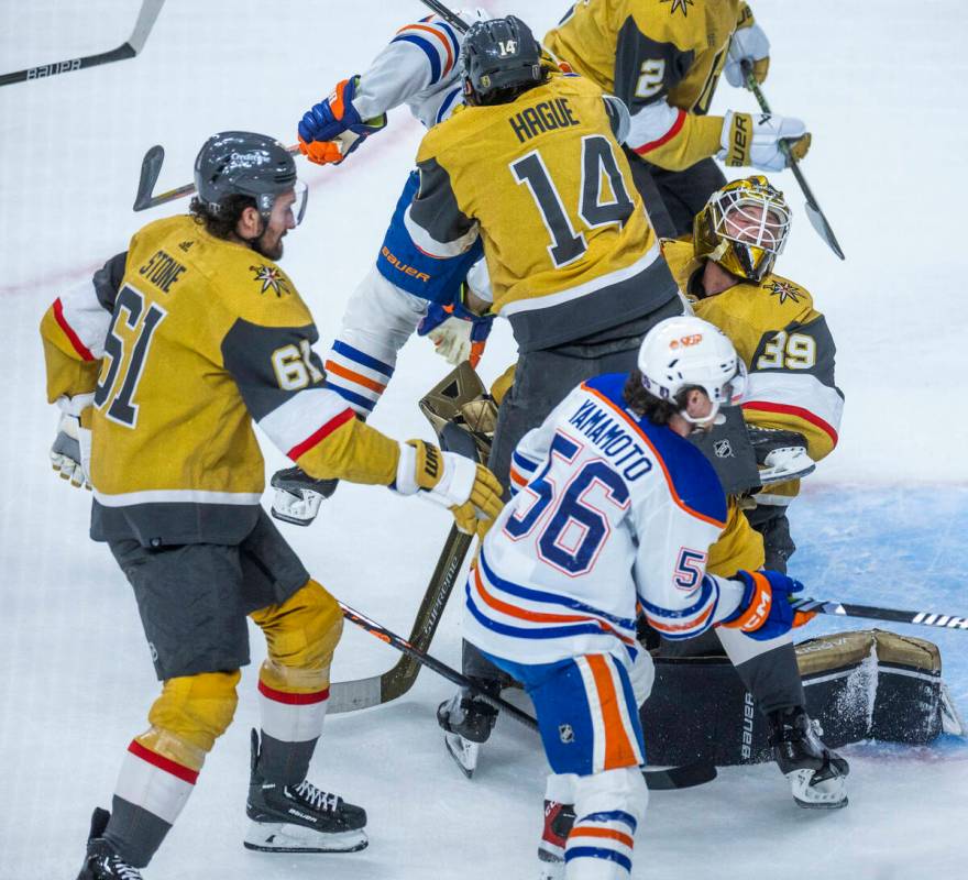 Golden Knights goaltender Laurent Brossoit (39) its collided into by teammate Golden Knights de ...