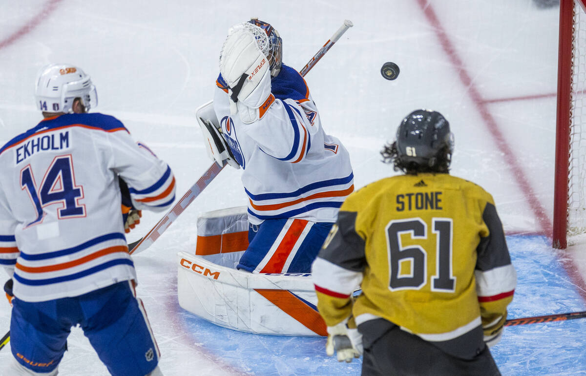 Edmonton Oilers goaltender Stuart Skinner (74) has the puck sail past but hitting the crossbar ...