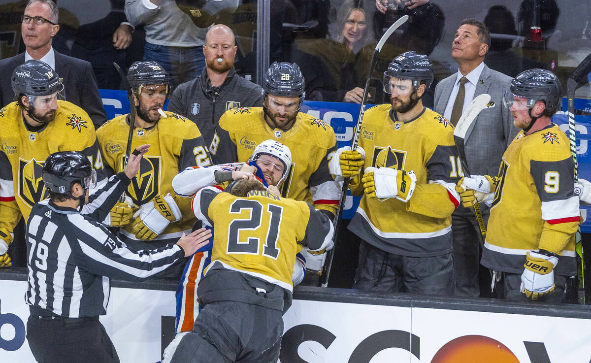 Golden Knights center Brett Howden (21) and Edmonton Oilers defenseman Brett Kulak (27) tangle ...