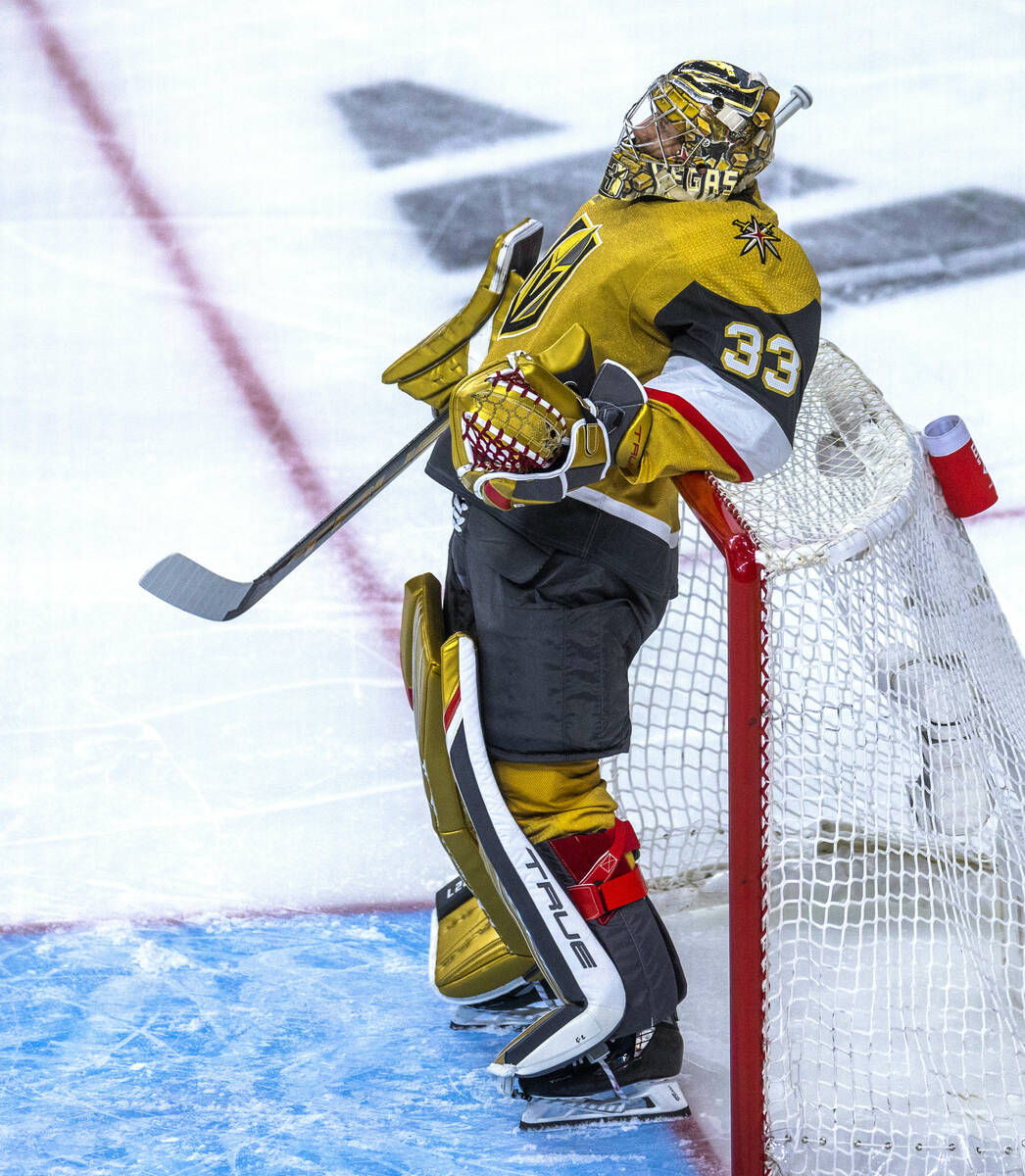 Golden Knights goaltender Adin Hill (33) leans back on the net during a face-off break against ...