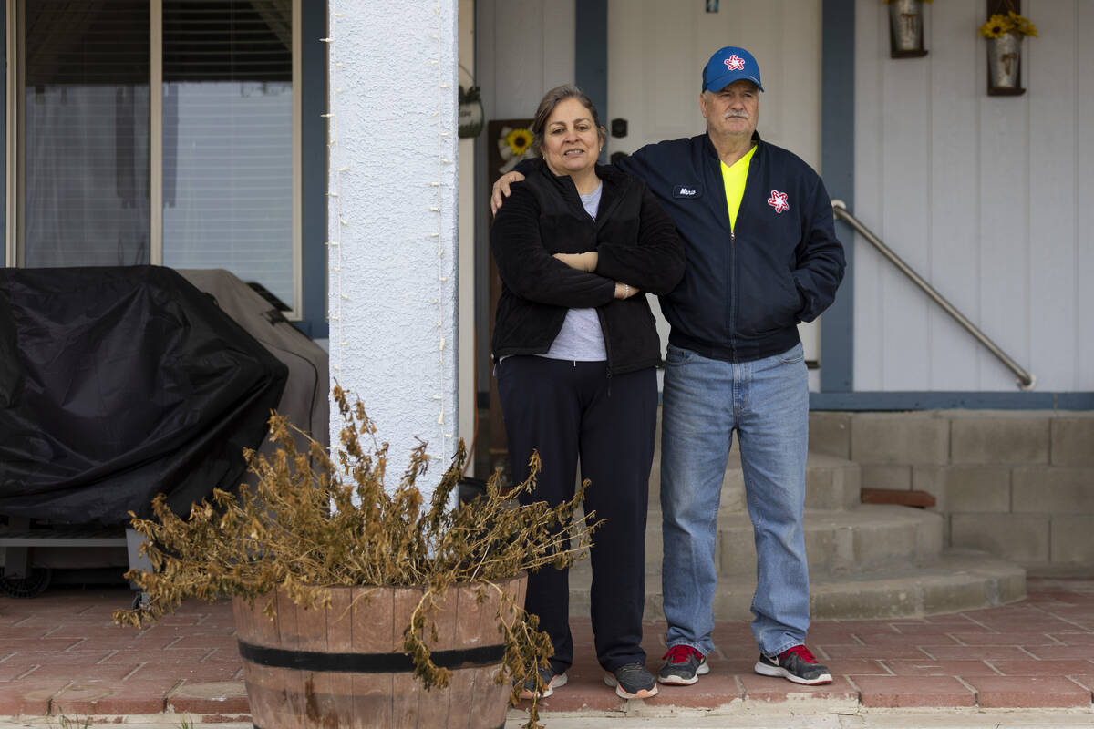 Alma Perez, left, with her husband Mario, stand outside of their home in the Lytle Ranch neighb ...