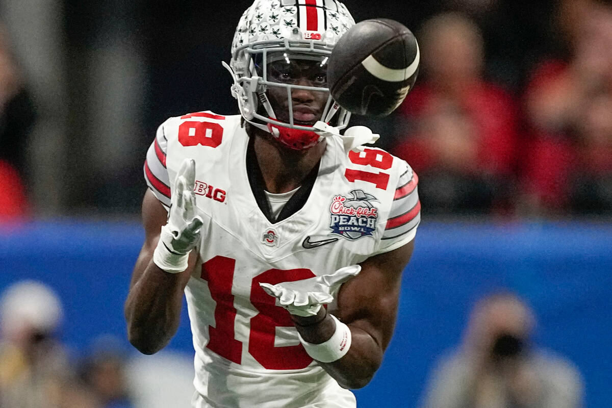 Ohio State wide receiver Marvin Harrison Jr. (18) makes a catch against Georgia during the firs ...