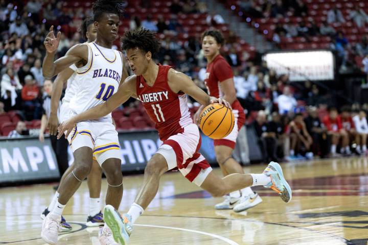 Liberty’s Dedan Thomas Jr. (11) drives around Durango’s Tylen Riley (10) during the first h ...