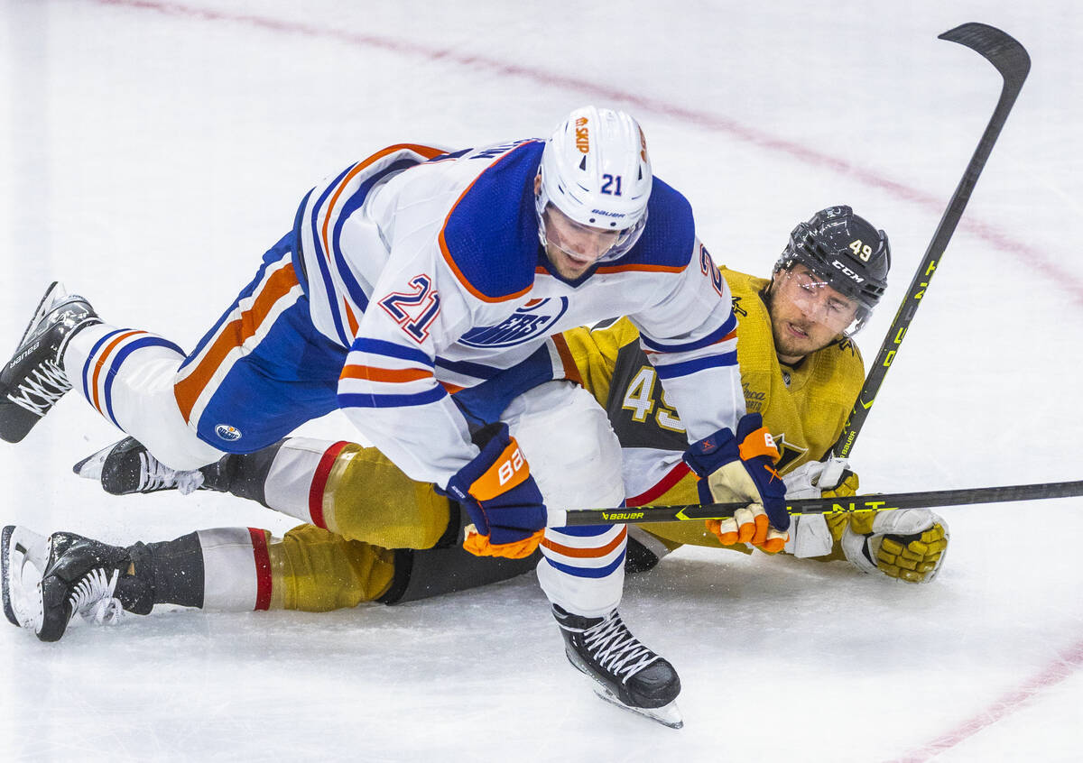 Edmonton Oilers center Klim Kostin (21) and Golden Knights center Ivan Barbashev (49) get tangl ...