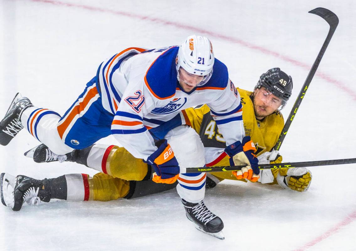 Edmonton Oilers center Klim Kostin (21) and Golden Knights center Ivan Barbashev (49) get tangl ...