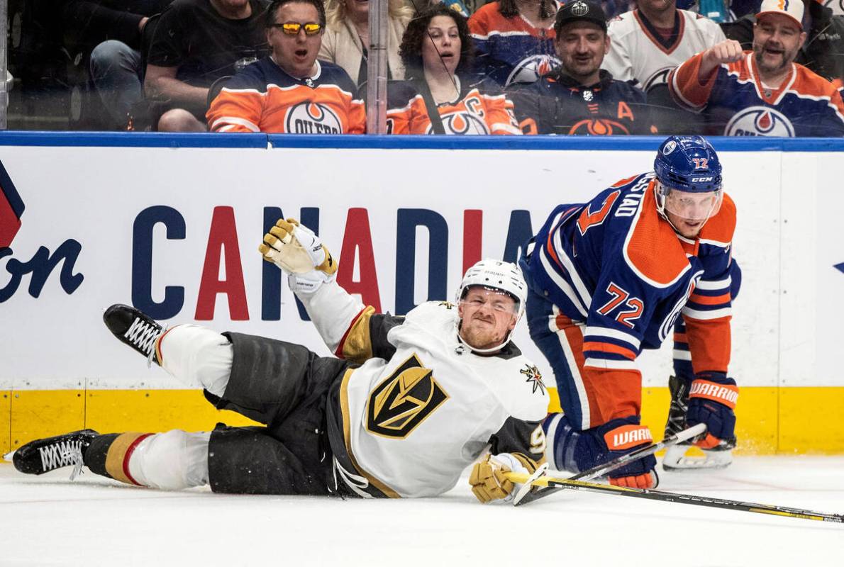 Vegas Golden Knights' Jack Eichel (9) is checked by Edmonton Oilers' Nick Bjugstad (72) during ...