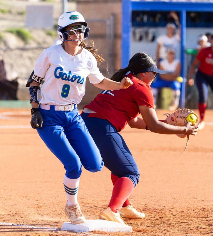 Green Valley High's Liliana Esparza (8) forced out at first by Liberty High's Joei Luevanos (32 ...