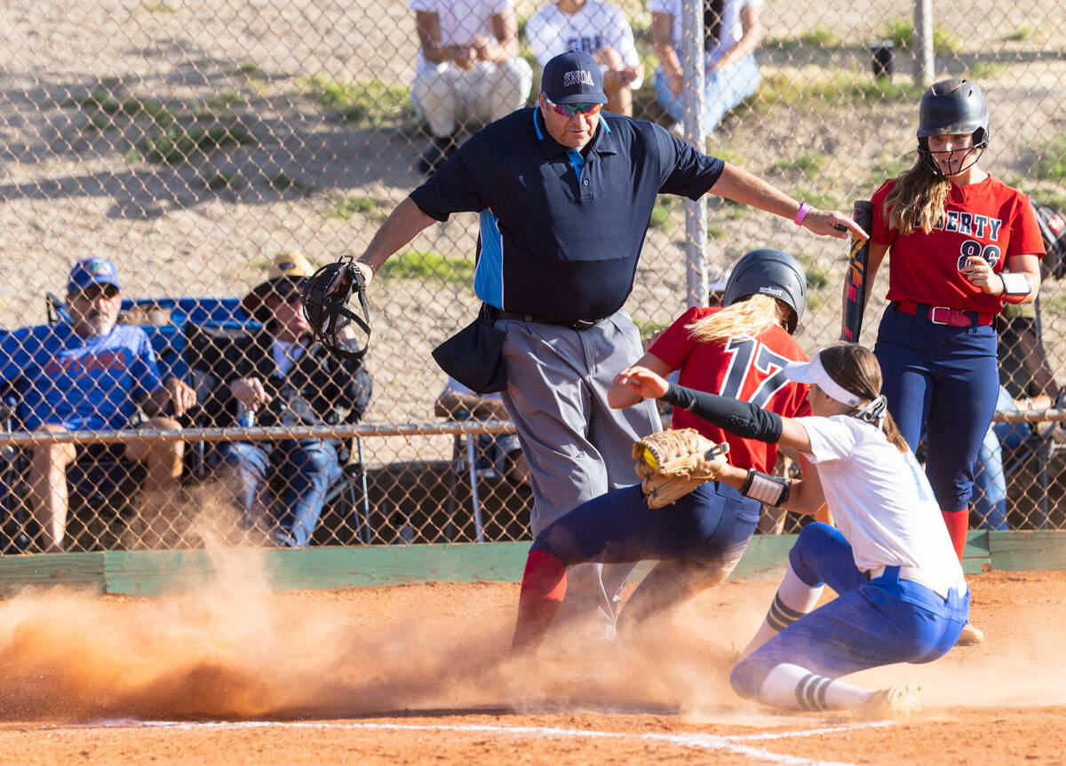 Liberty High's Jesse Farrell (17) scores at home as Green Valley High's pitcher Avari Morris (1 ...