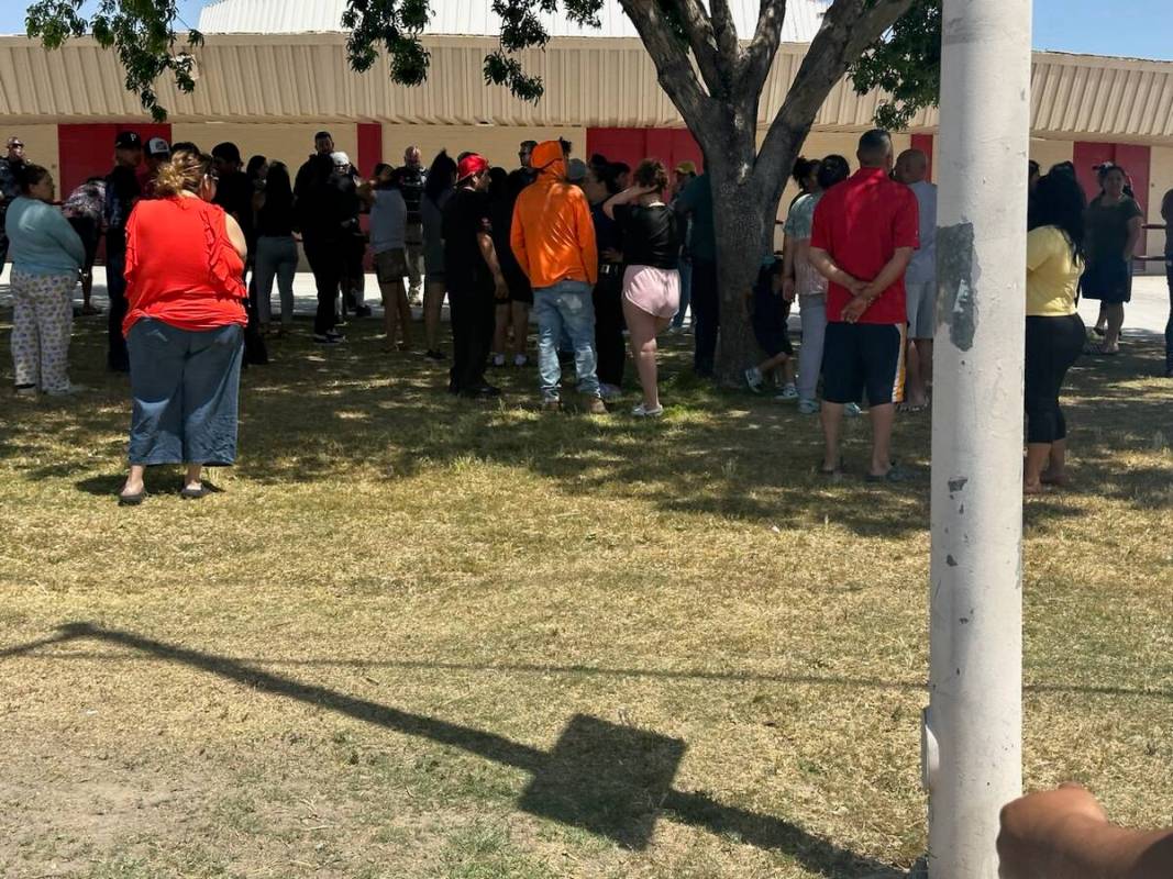 People stand outside of Ed Von Tobel Middle School as Clark County School District police respo ...