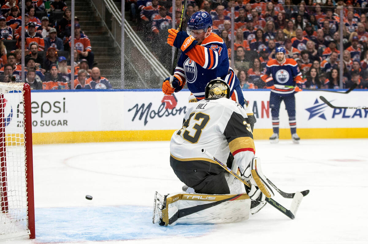 Vegas Golden Knights goalie Adin Hill (33) makes a save against Edmonton Oilers' Klim Kostin (2 ...