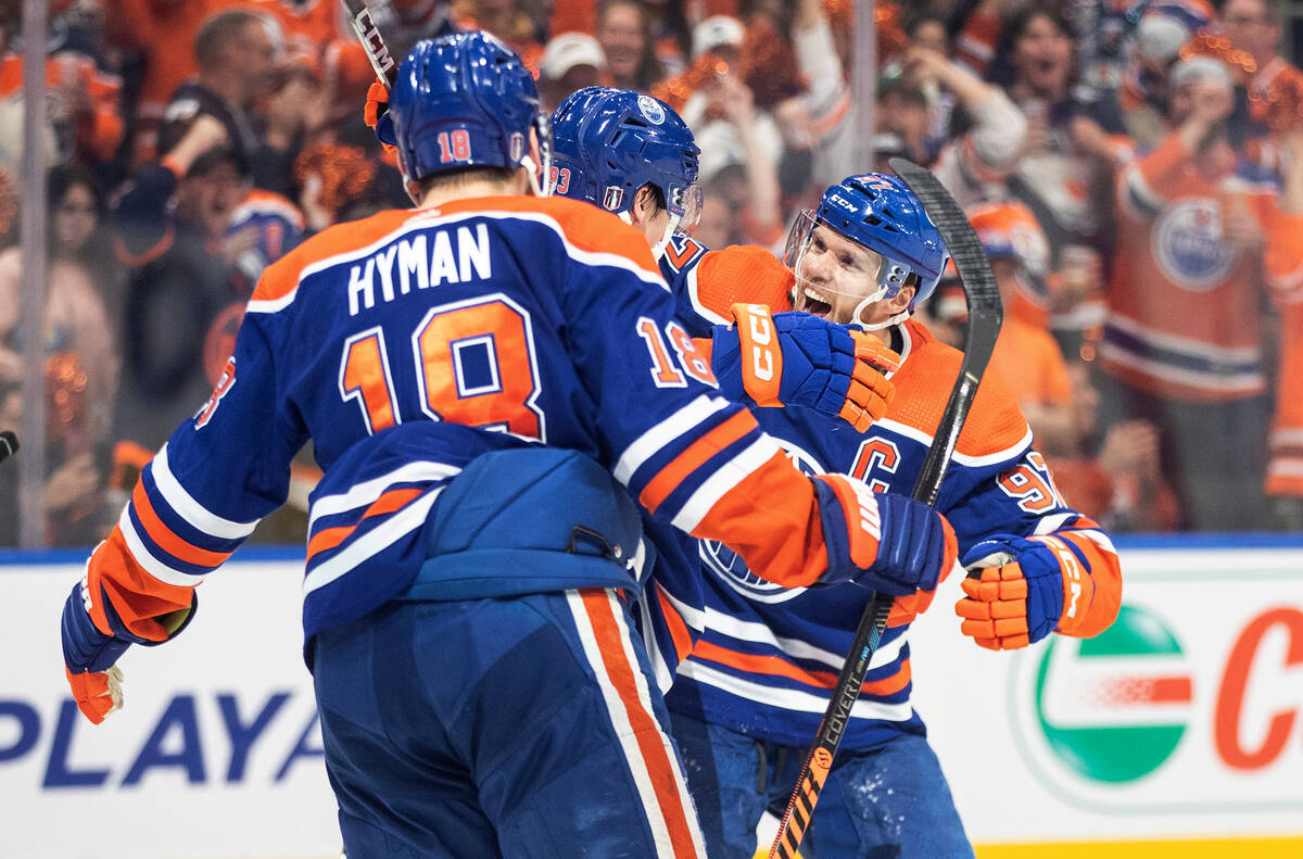 Edmonton Oilers' Zach Hyman (18), Ryan Nugent-Hopkins (93) and Connor McDavid (97) celebrate a ...