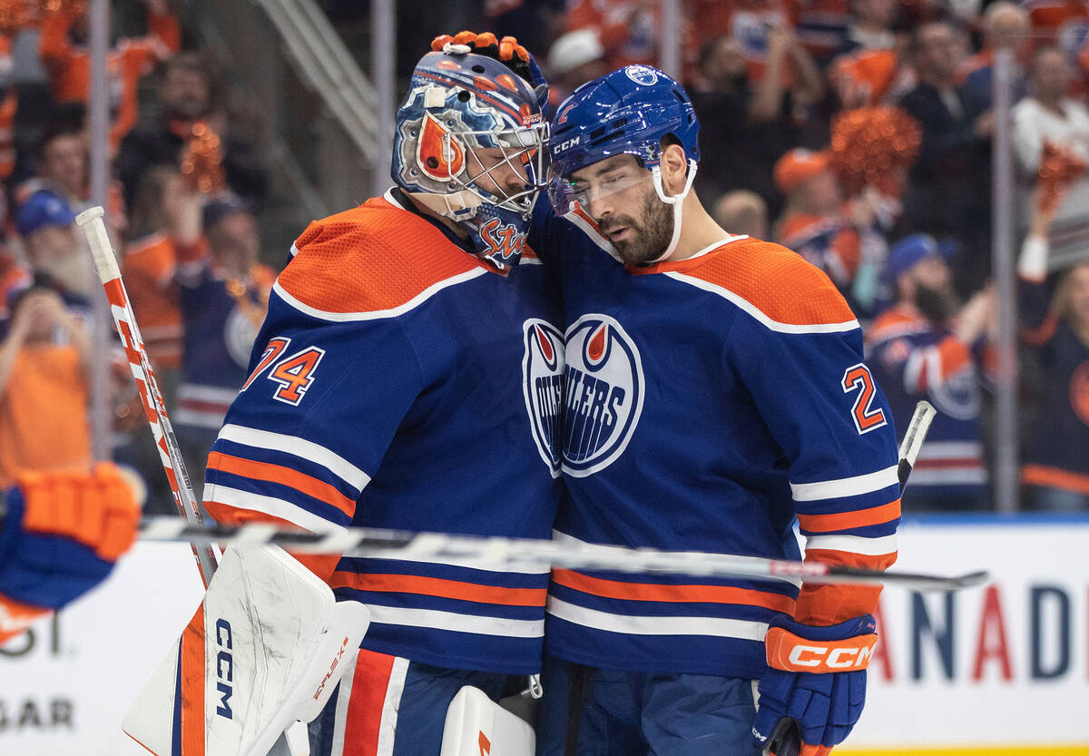 Edmonton Oilers' Stuart Skinner (74) and Evan Bouchard (2) celebrate the team's 4-1 win over th ...