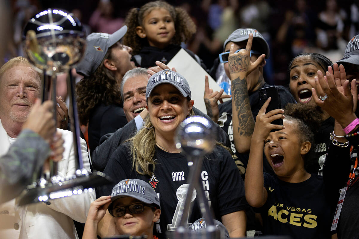 Las Vegas Aces owner Mark Davis, left, and head coach Becky Hammon stand alongside their cheeri ...