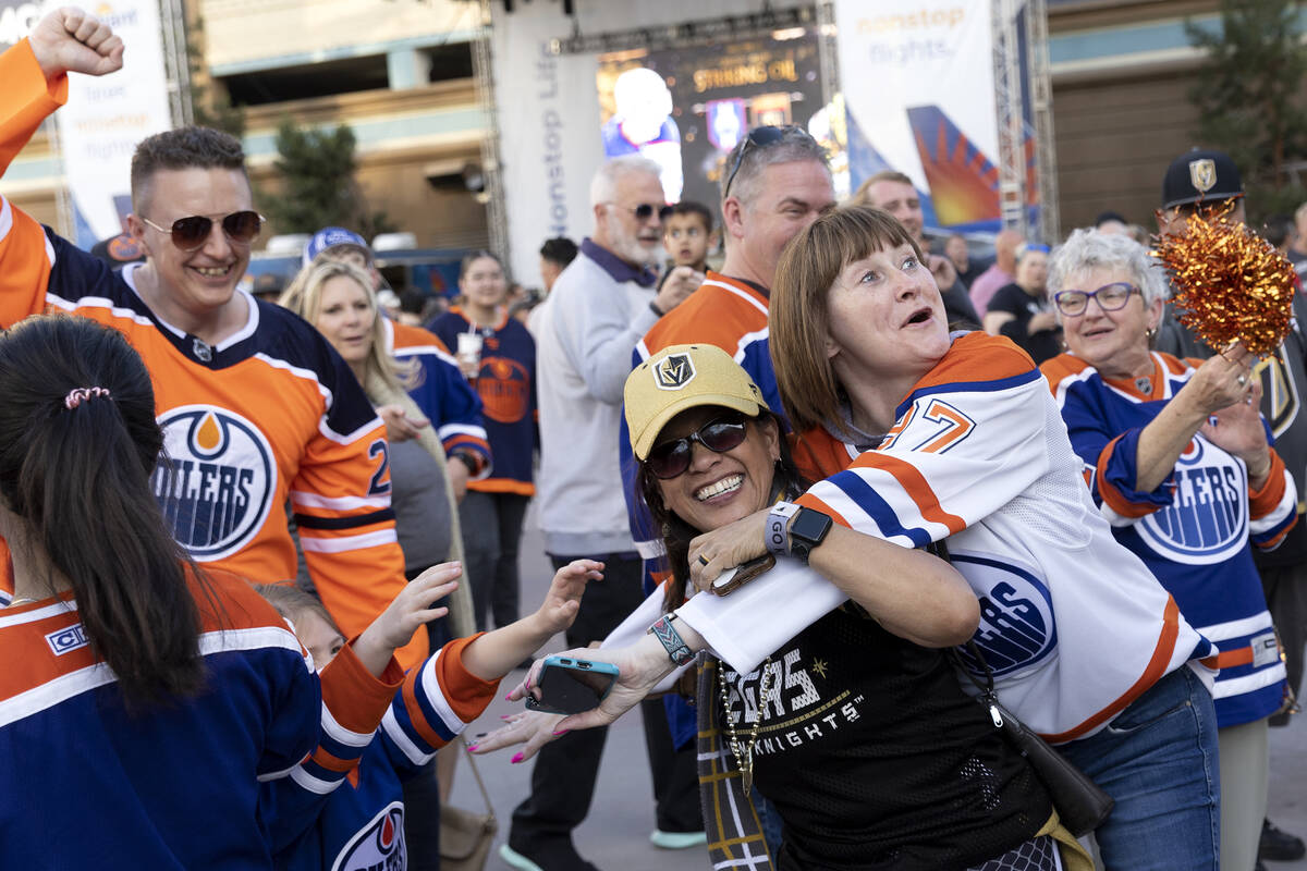 Dion Glenn, center left, a Golden Knights fan, interrupts Edmonton Oilers fans while they cheer ...