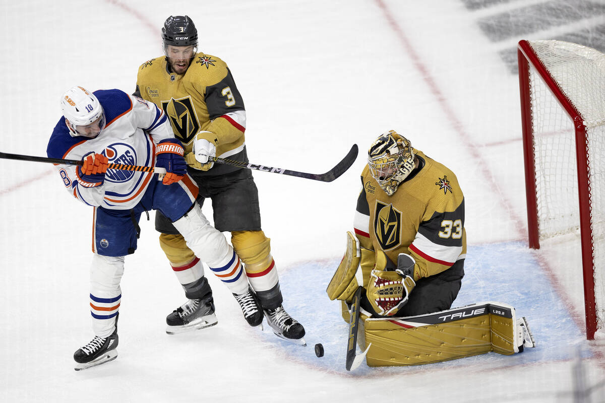 Golden Knights goaltender Adin Hill (33) saves the puck against Edmonton Oilers left wing Zach ...