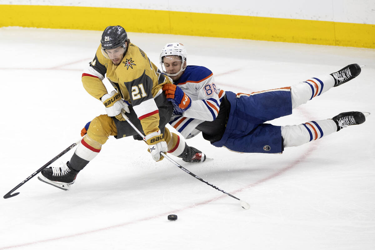 Edmonton Oilers defenseman Philip Broberg (86) hangs onto Golden Knights center Brett Howden (2 ...