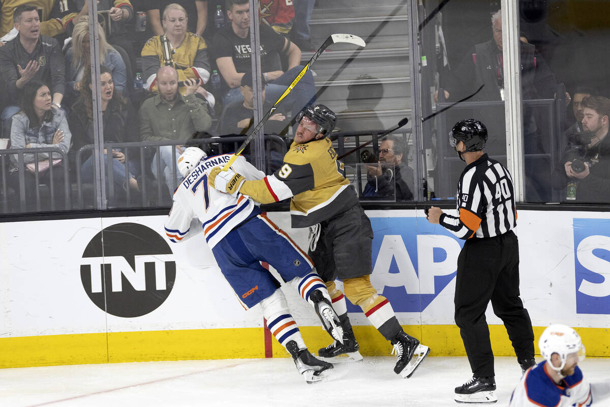 Golden Knights center Jack Eichel (9) shoves Edmonton Oilers defenseman Vincent Desharnais (73) ...