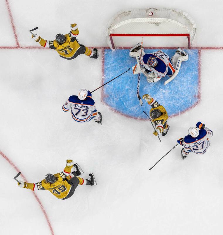 Golden Knights players celebrate a Mark Stone goal past Edmonton Oilers goaltender Stuart Skinn ...