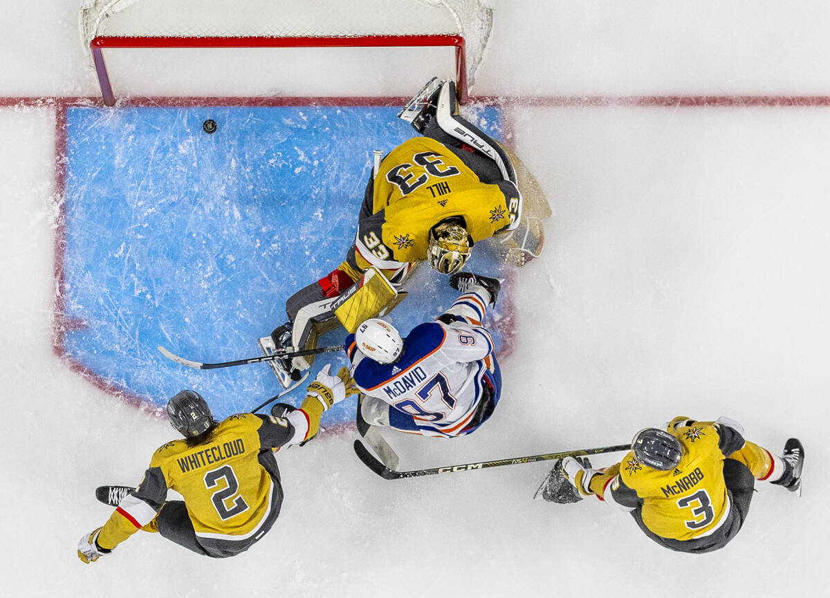 Edmonton Oilers center Connor McDavid (97) scores past Golden Knights goaltender Adin Hill (33) ...